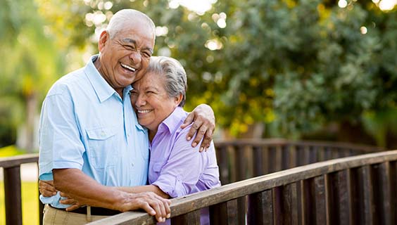 Mexican senior couple laughing on bridge